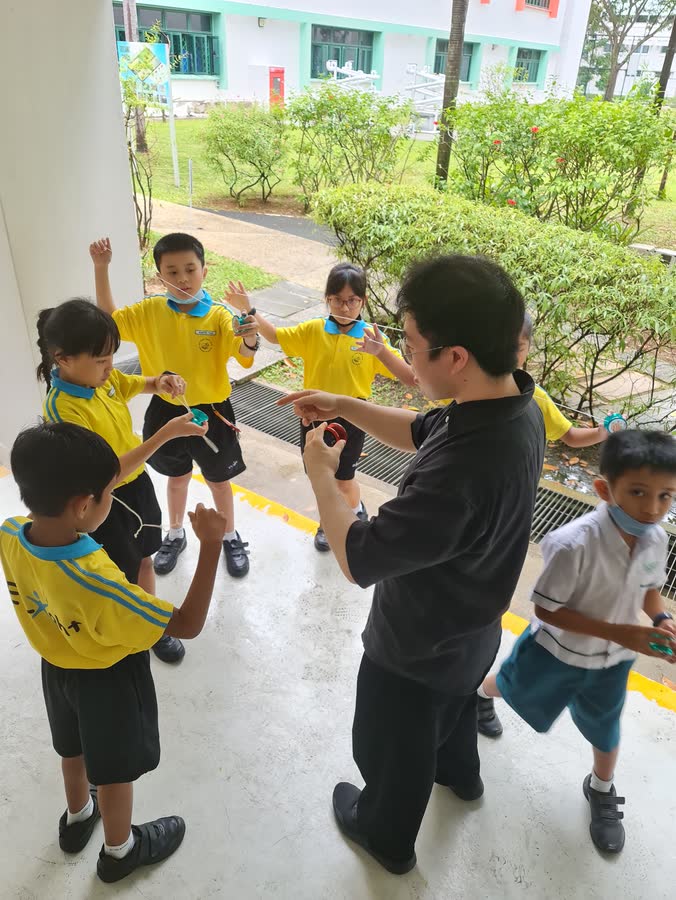 Yoyo instructor teaching primary school students